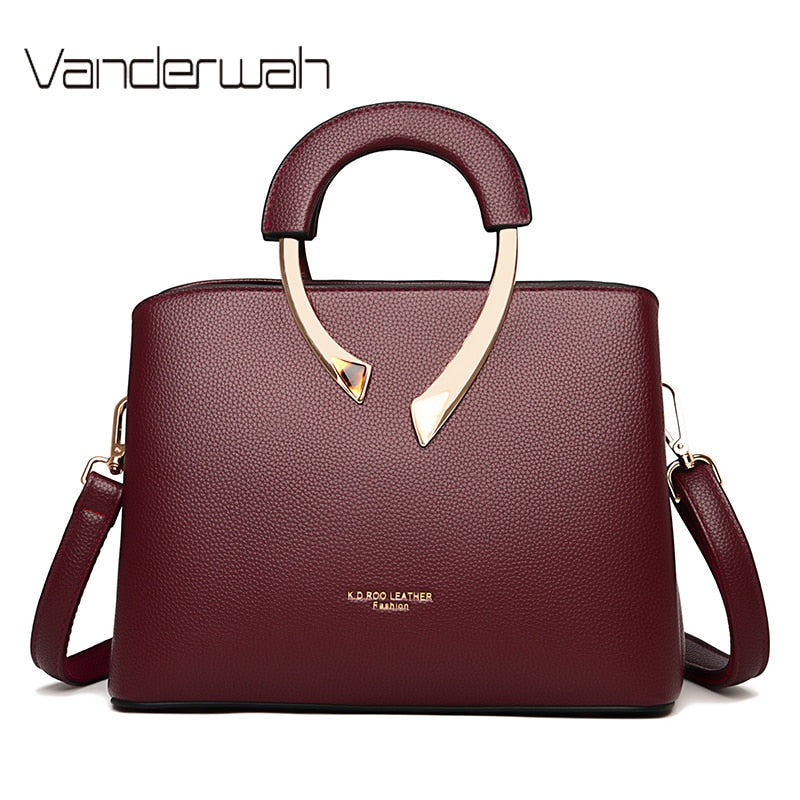A faux-leather shoulder bag in a stone neutral — the quiet palette in leather form